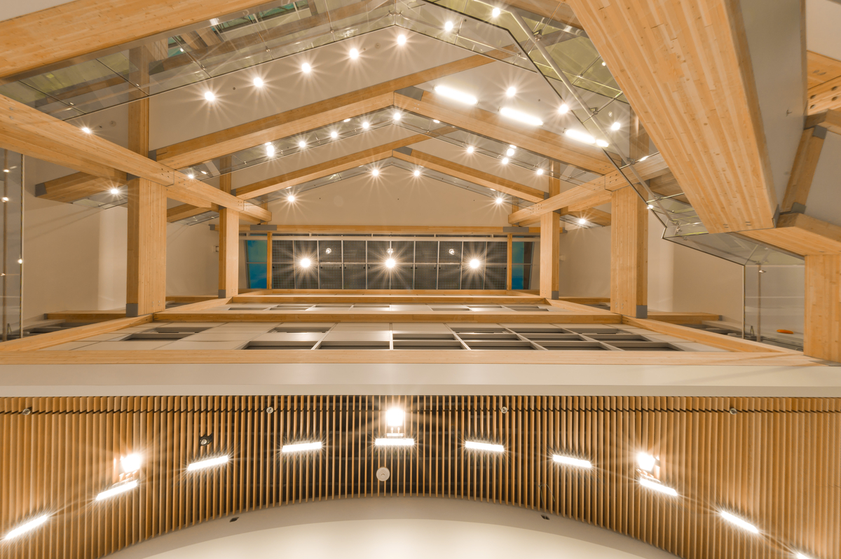 在可持续发展互动研究中心(CIRS)向上的四层室内中庭视图中，以胶合木梁和可持续设计为特色。